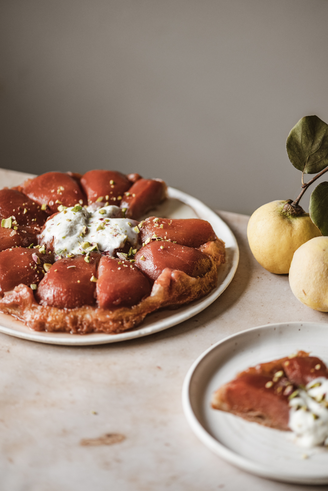 This quince tarte tatin topped with cardamom crème fraîche & pistachios is the ultimate way to display the glory of this ancient fruit