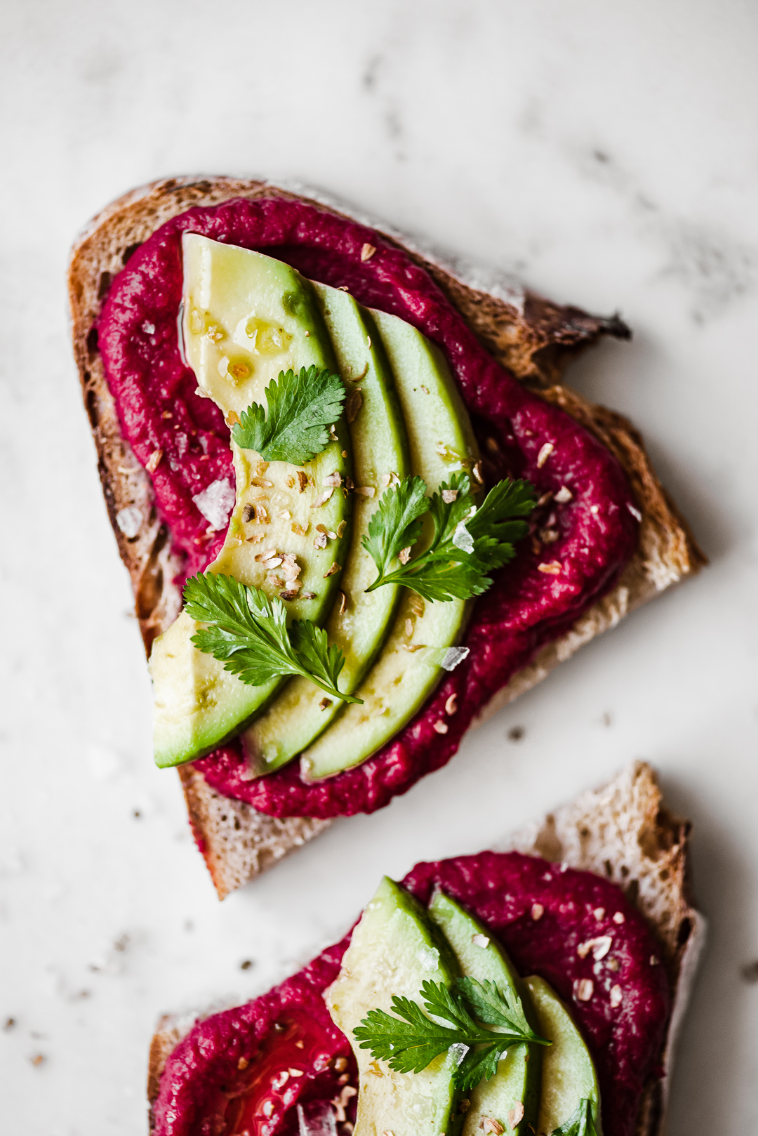 beet hummus with avocado slices + crushed coriander seeds + cilantro