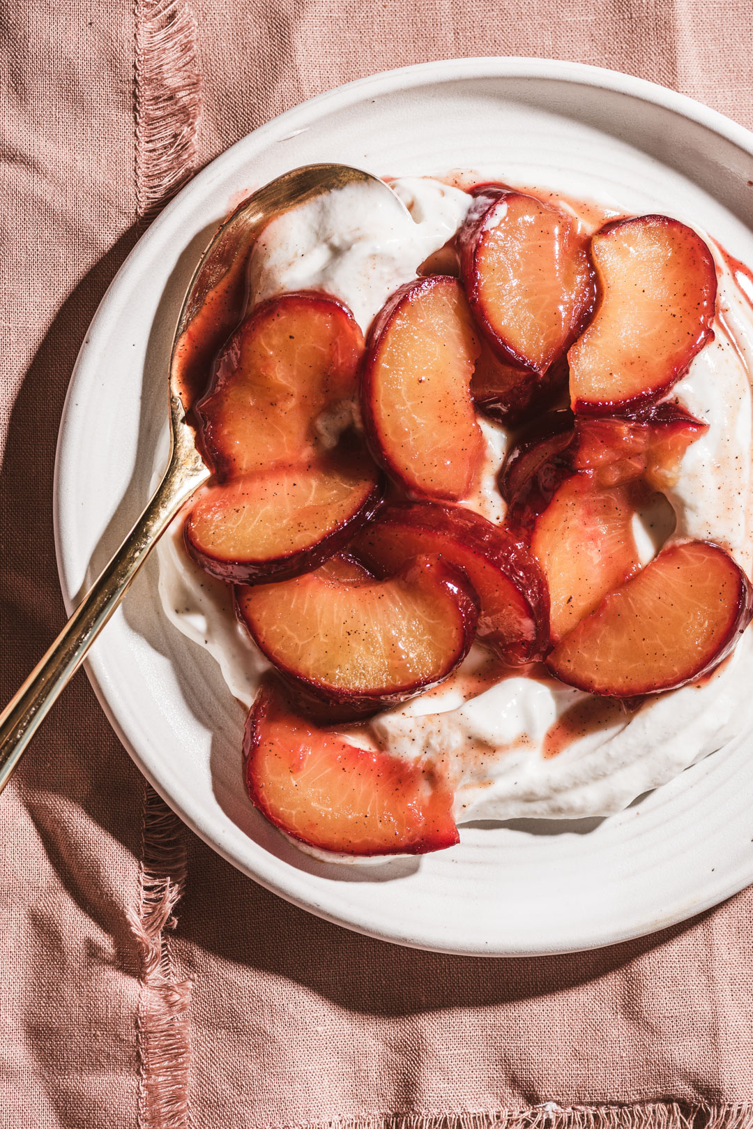 Sautéeing plums in a bit of butter, honey & vanilla is the simplest way to transform them. They become luscious, ruby tinged jewels ready to adorn your everyday eats. Enjoy them atop a simple bowl of yogurt, ice cream, oatmeal or pancakes. These simple sautéed plums will make you reconsider simply eating a plum out of hand.