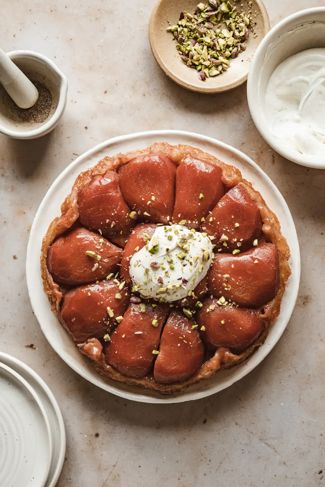 This quince tarte tatin topped with cardamom crème fraîche & pistachios is the ultimate way to display the glory of this ancient fruit