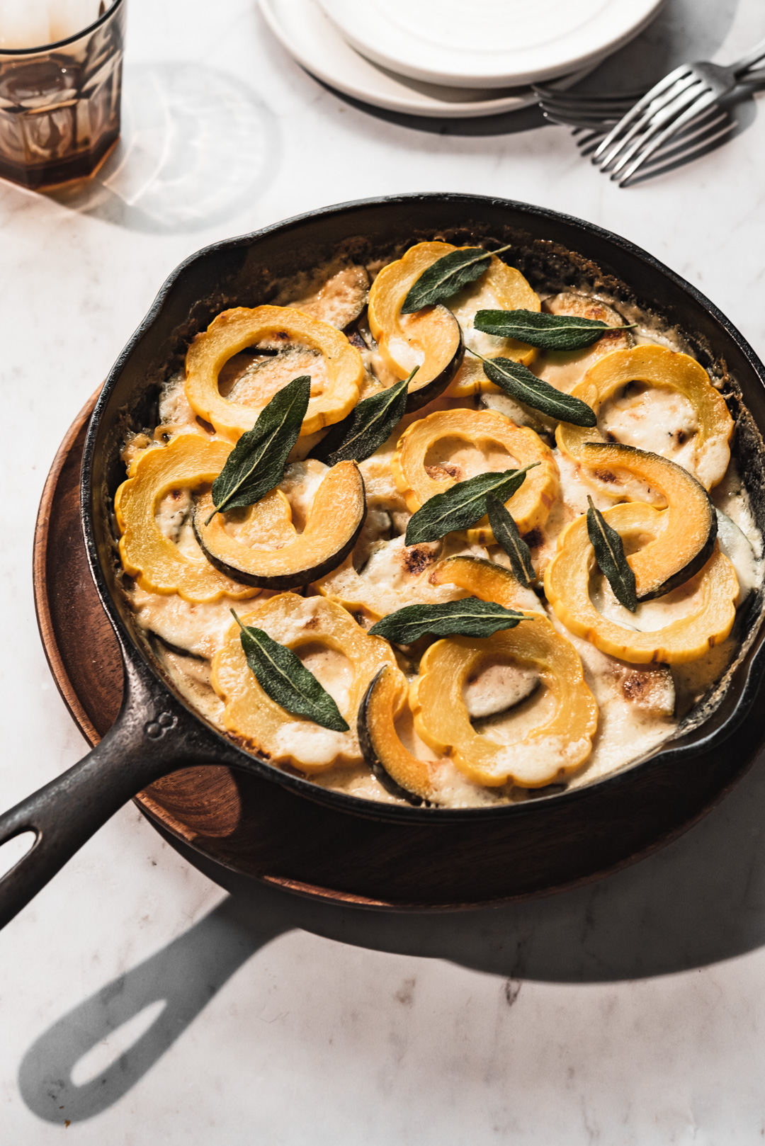 This creamy, cheesy winter squash au gratin topped with crispy sage leaves is a delicious vegetarian main course or side dish to a roast.