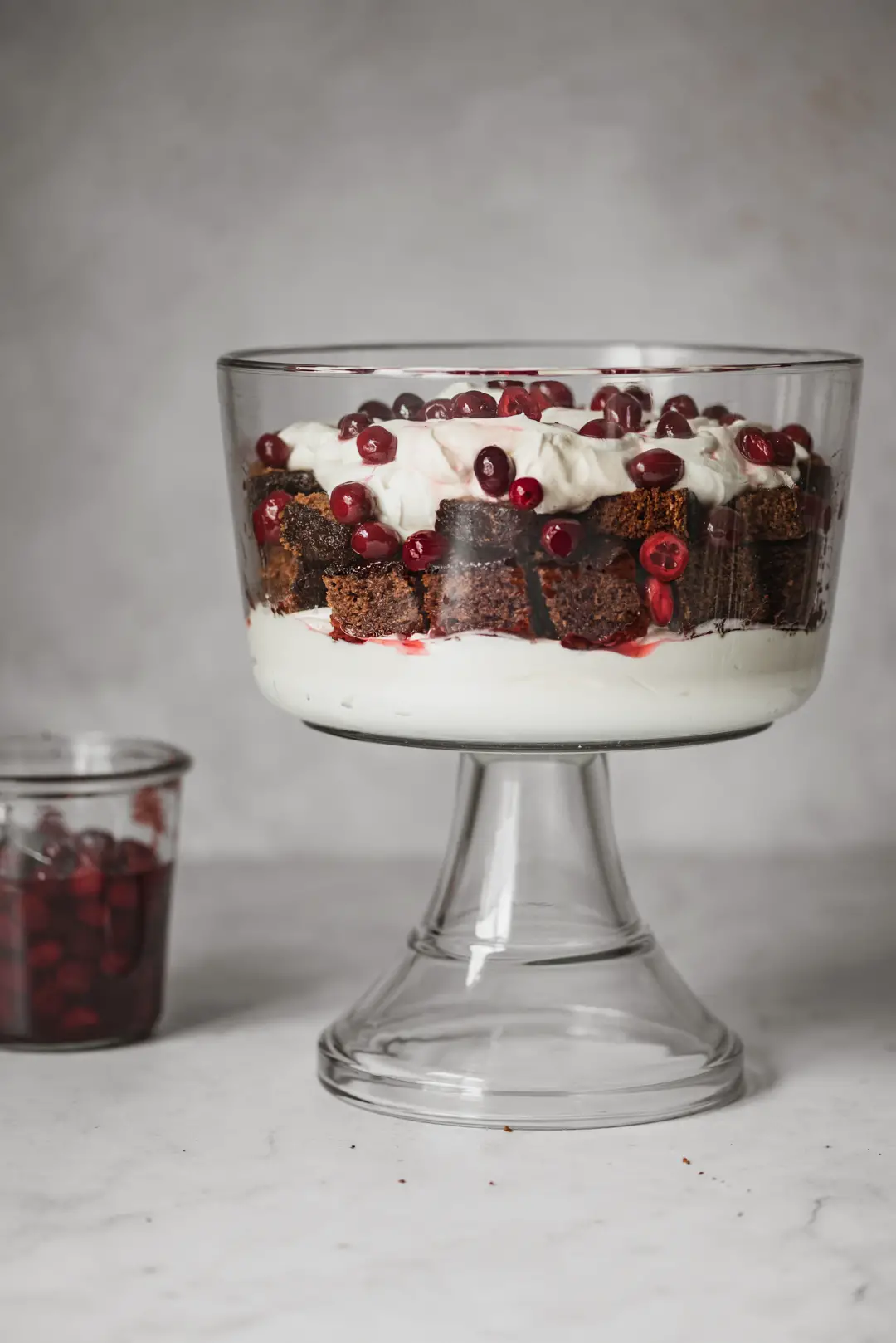 This festive trifle features sticky gingerbread spice cake, luscious whipped cheesecake & soft candied cranberries.